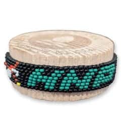 Women’s beaded bracelet with "HANDS" inscription in turquoise beads on black background.