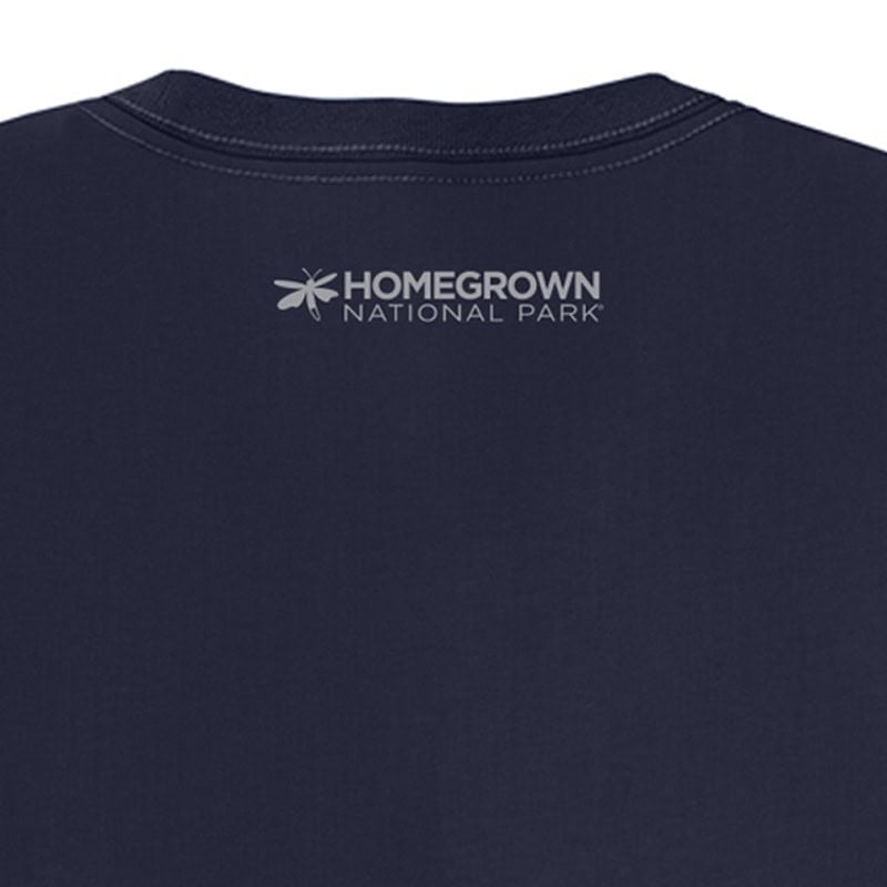 Close-up of a navy blue T-shirt featuring the "Homegrown National Park" logo with a bee icon, showcasing inspirational merchandise supporting conservation efforts.