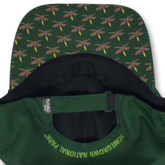 Green cap with "Homegrown National Park" embroidered in yellow, featuring a patterned brim with dragonflies in brown and yellow on a dark green background. Perfect for eco-conscious outdoor enthusiasts.