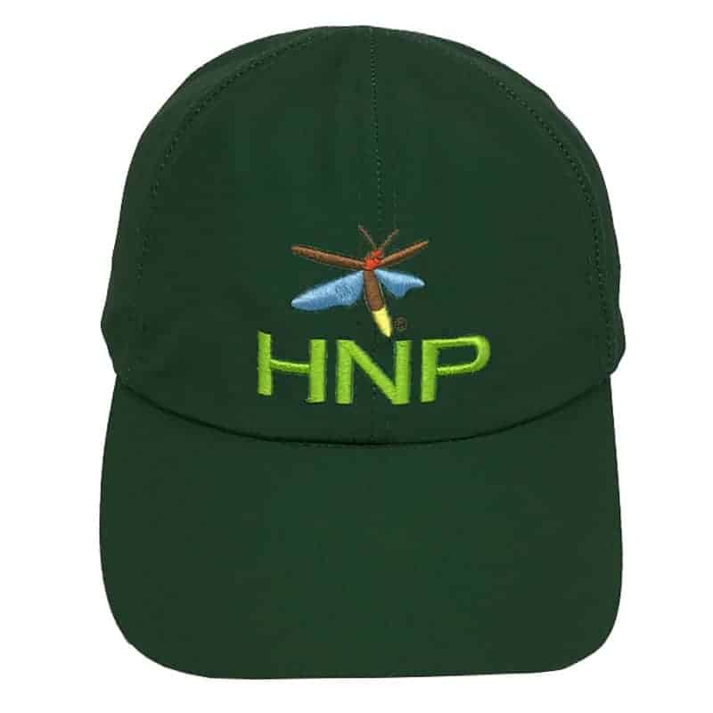 Dragonfly embroidered patch with HNP lettering on dark green baseball cap, representing Homegrown National Park merchandise and conservation efforts, eco-friendly apparel accessory.